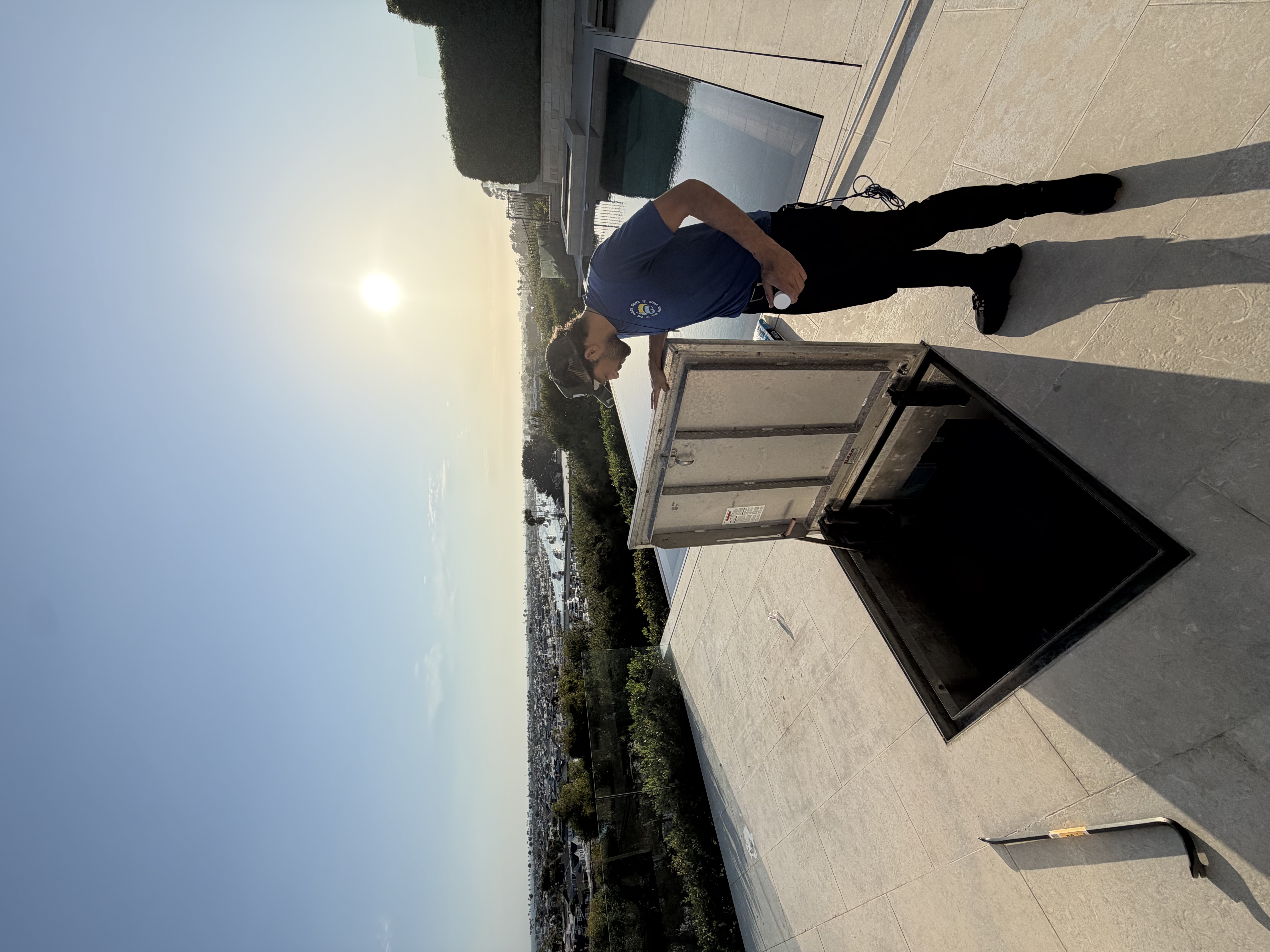 Technician at an open pool equipment vault hatch